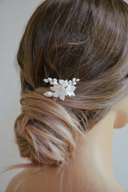 Floral bridal hair pin styled in an updo hairstyle.