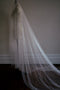 Side view of the cathedral-length OPERA pearl veil draped on a dress form.