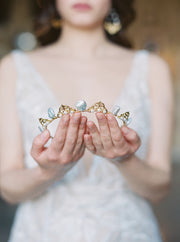 delicate bridal pearl tiara being held in the hands.