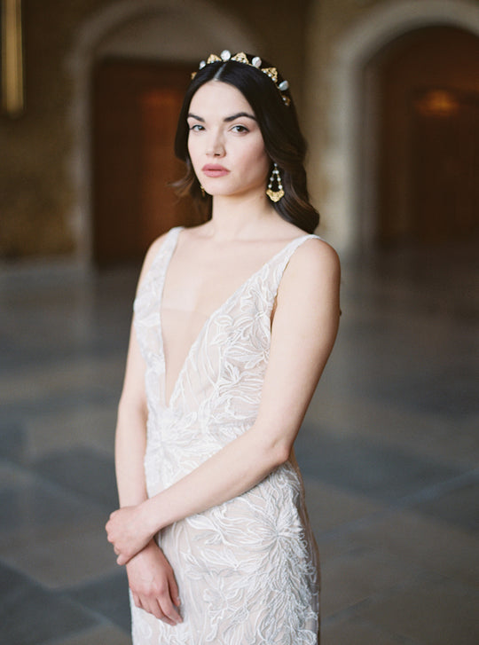 Delicate pearl tiara styled with chandelier earrings.