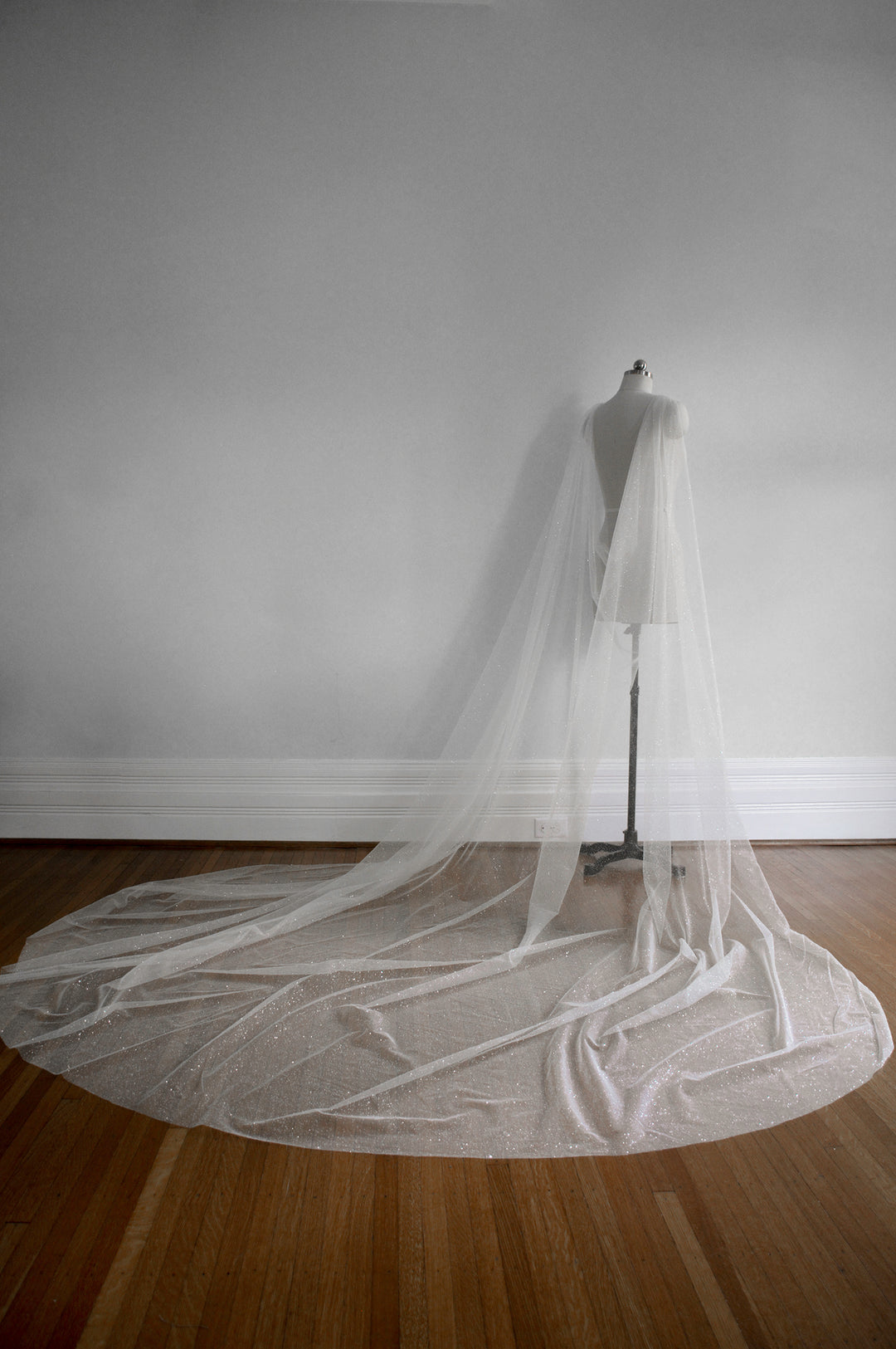 sparkly bridal cape veil with a wide train