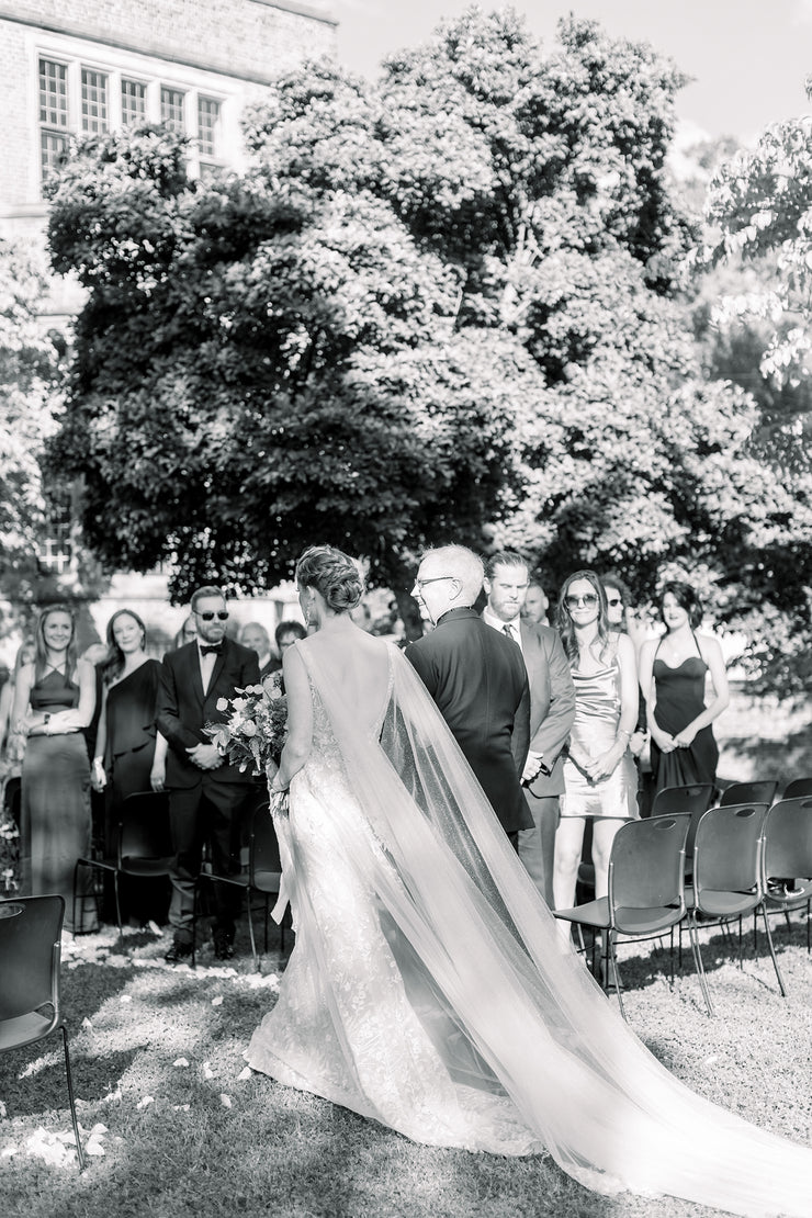 wedding cape on bride walking down the aisle with her father