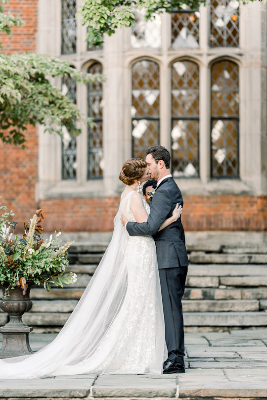 sparkly wedding cape worn by bride at wedding first kiss